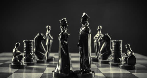 king and queen chess pieces on a chessboard