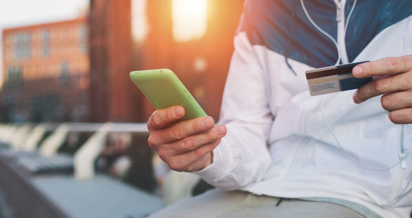 Millenial using phone to make an online purchase