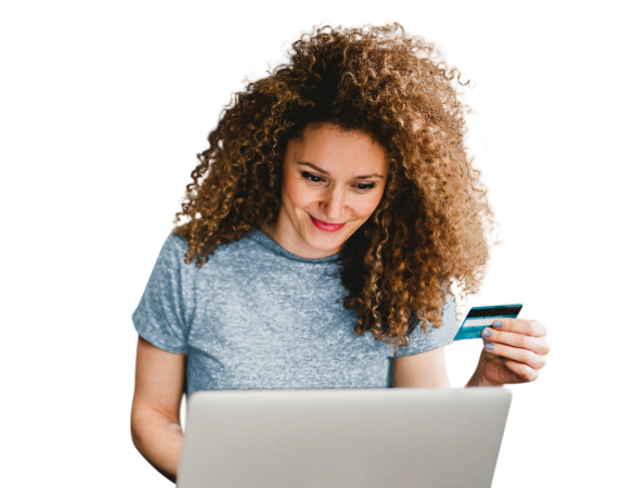 Woman using a laptop and holding a credit card to buy online